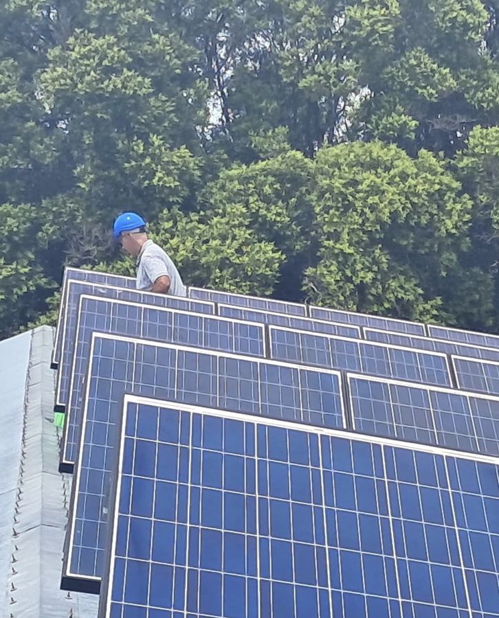 Instalador entre filas de paneles solares montados sobre estructuras inclinadas